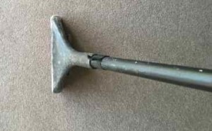 Carpet cleaning wand on beige carpet surface