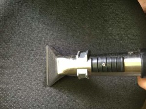 Upholstery cleaning tool on fabric surface